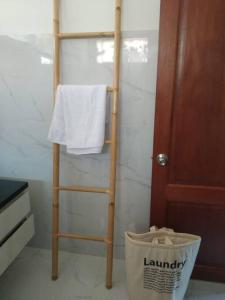 a towel rack in a bathroom with a white towel at Private Luxury Villa in private beach resort in Telukmataikan