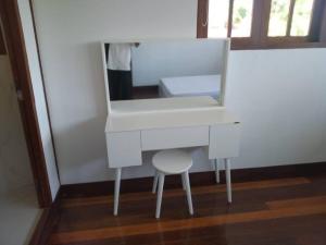 a white dressing table with a stool and a mirror at Private Luxury Villa in private beach resort in Telukmataikan +23 photos