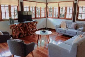 a living room with a tv and a couch and a table at Private Luxury Villa in private beach resort in Telukmataikan