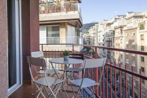 a balcony with a table and chairs on a balcony at 73cop1034 - Spacious apartment with terrace in Barcelona