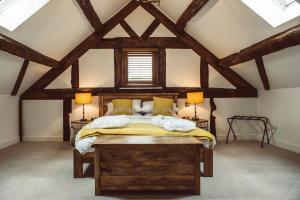 a bedroom with a wooden bed in a attic at Swallows Rest in Montgomery