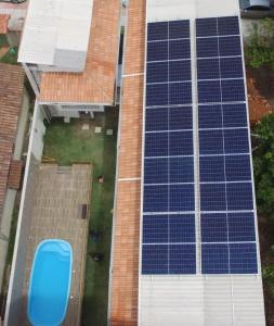 an overhead view of a building with blue solar panels at Pousada Sonho Meu in Itaúnas