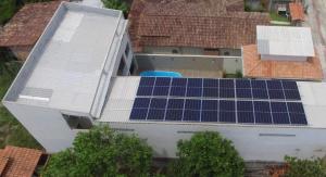 an aerial view of a house with solar panels on the roof at Pousada Sonho Meu in Itaúnas