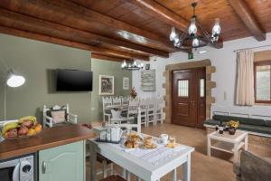 a kitchen and living room with a table with fruit on it at Villa Gianna by PosarelliVillas in Fílippos