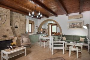 a kitchen and living room with a stone wall at Villa Gianna by PosarelliVillas in Fílippos