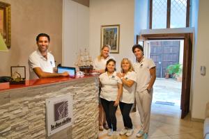 a group of people posing for a picture in a salon at Le Due Sicilie in Tropea