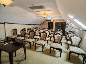 a row of chairs in a room with a table at Hotel Carol in Constanţa