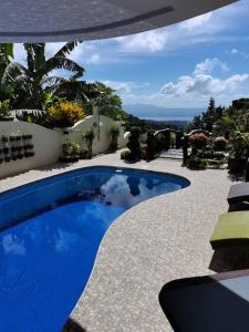 a blue swimming pool on the side of a building at Avana Hills Tagaytay Villa in Tagaytay