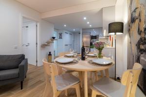 a dining room and kitchen with a table and chairs at The View House - Sesimbra in Sesimbra