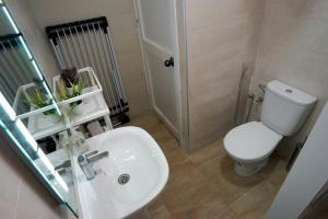 a bathroom with a white toilet and a sink at Tetouan Luxury Apartment in Tétouan