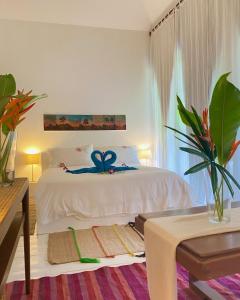 a bedroom with a bed with a blue ribbon on it at Maddekehaoo Eco Mansion in Ko Chang