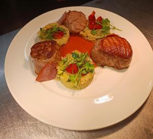 a plate of food with meat and vegetables on a table at Dukes Folly Hotel in Southport