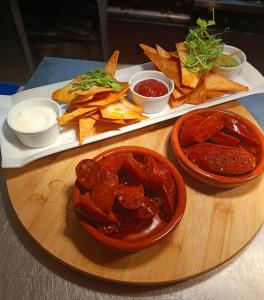 a table with a plate of food with chips and dips at Dukes Folly Hotel in Southport