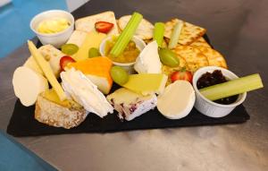 a plate of different types of cheese and other foods at Dukes Folly Hotel in Southport