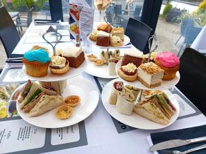 a table topped with plates of cakes and pastries at Dukes Folly Hotel in Southport