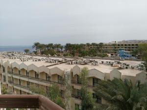 a large building with tables and chairs on the roof at Golden Rose Hotel in Hurghada