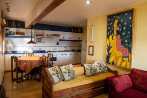 a living room with a couch and a table at Los Gualles de la Candelaria Apart Hotel in Pucón