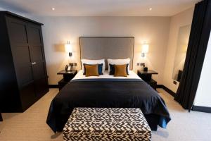 a bedroom with a large bed with two pillows at The Chester Hotel in Aberdeen