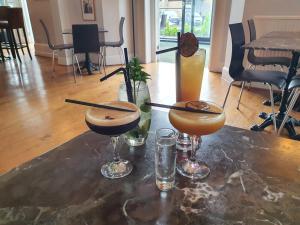 a table with two cocktails and two glasses on it at Dukes Folly Hotel in Southport