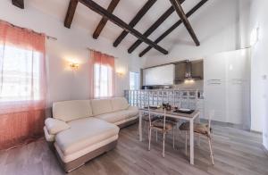uma sala de estar com um sofá e uma mesa em Ca' Laura - Murano Centro em Murano
