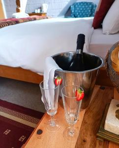 a bottle of wine and two glasses on a table at Dukes Folly Hotel in Southport