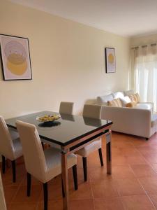 a living room with a table and a couch at Condominio do Mar in Lagos