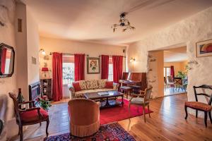 a living room with a couch and a table at Sundrenched Relais de Poste in Serdinya in Serdinya