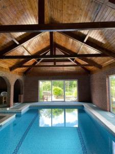 a swimming pool in a building with a ceiling at Betty's Cottage - Traditional Norfolk Farm Cottage in Swafield