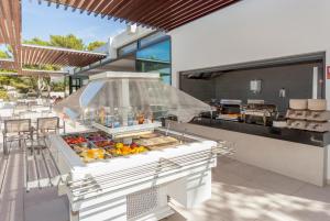 a food court with a buffet of food at Sun Club El Dorado - All Inclusive in Llucmajor