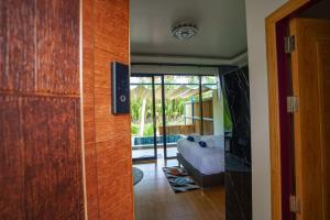 a room with a door leading to a bedroom with a bed at Phetra pool villas in Surat Thani