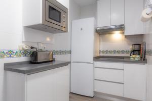 A kitchen or kitchenette at Atico Lujoso