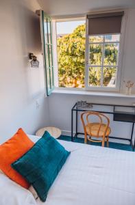 a bedroom with a bed and a window and a desk at Bigouden Makers in Pont-lʼAbbé