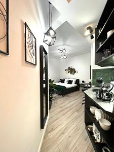 a kitchen and living room with a bed in a room at Green Spot - Premium Studio - Sanador Victoriei in Bucharest