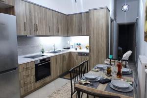 a kitchen with a table and chairs and a kitchen with a refrigerator at Modern apartment in Itea in Itea