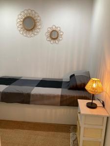 a bedroom with a bed and a mirror on the wall at The View House - Sesimbra in Sesimbra +18 photos