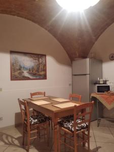 a kitchen with a table and chairs and a refrigerator at B&B LA BOUGANVILLE in Spoltore