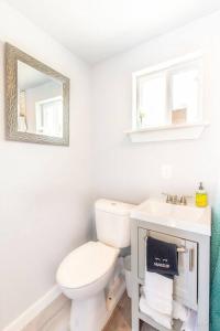 a white bathroom with a toilet and a sink at The Container Retreat @290 Wine Trail #3 Hill Country bliss in Hye +27 photos