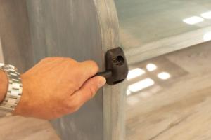 a person opening a glass door with a handle at The Container Retreat @290 Wine Trail #3 Hill Country bliss in Hye