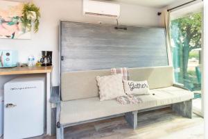 a bench in a room with a large window at The Container Retreat @290 Wine Trail #3 Hill Country bliss in Hye