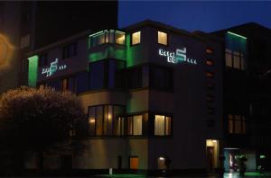 a building with green lights on it at night at Do Stil Boutique Hotel in Timişoara