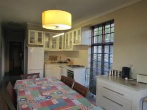 a kitchen with a table and a kitchen with a table and chairs at Mafube Mountain Retreat in Fouriesburg