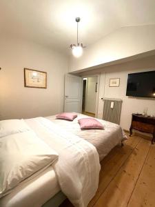 una camera da letto con un grande letto bianco con cuscini rosa di Villa Vitturi a Maserada sul Piave