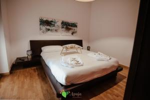 - une chambre avec un grand lit et des draps blancs dans l'établissement Apuja - Apulian Experience, à Bari