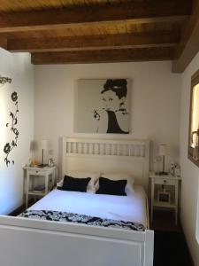 a bedroom with a white bed and two tables at Espléndido ático en Sallent con vistas (Wi-Fi) in Sallent de Gállego