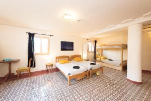 a bedroom with two beds and a pole at Eco-hôtel et Yourtes du Mercantour in Guillaumes