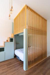 a bedroom with a bunk bed and a staircase at Studio tout confort à deux pas de l'océan - Wifi in Biscarrosse