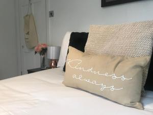 a bed with a pillow with the words anniversary at Mill Cottage Modern Boutique Cosy Home in Lake District Village near Scafell in Gosforth