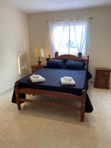 a bedroom with a bed with two towels on it at Casa Los Perales in San Salvador de Jujuy