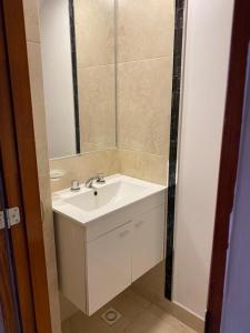 a bathroom with a white sink and a mirror at Casa Los Perales in San Salvador de Jujuy