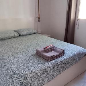 a bed with a towel on top of it at Avra House in Limassol